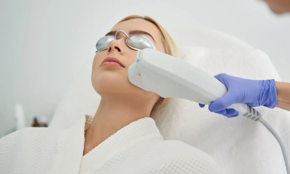 A young woman receives a Moxi laser treatment from a professional in Stillwater, OK