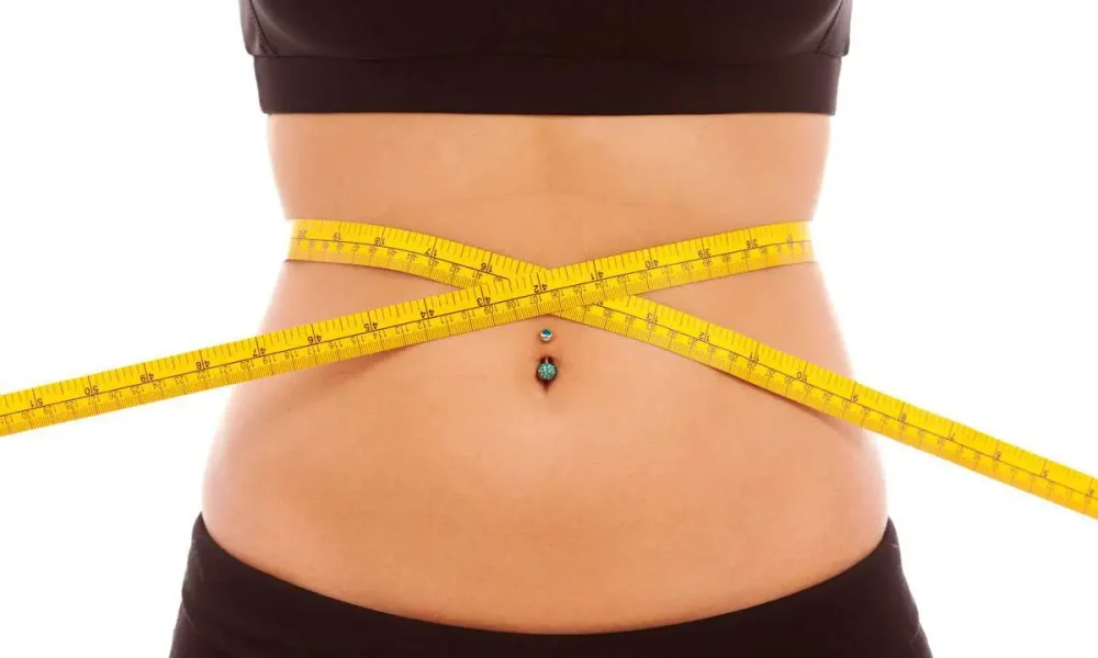 Slim waist with tape measure at PureSkin Aesthetics Stillwater